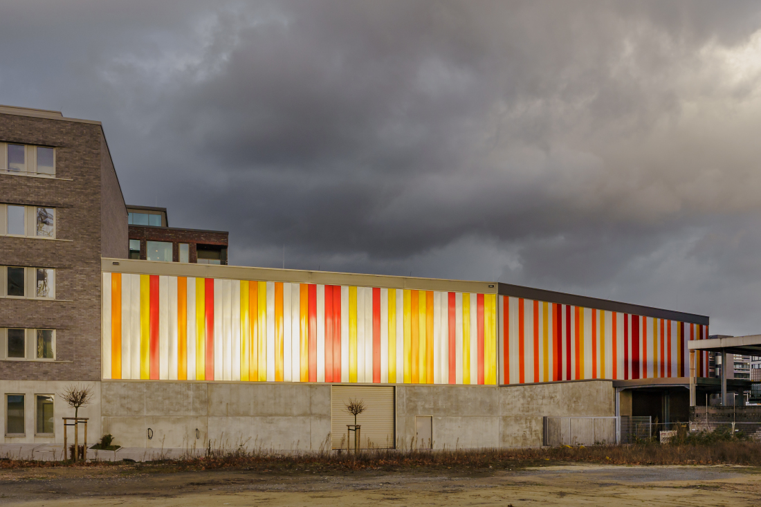 Grey clouds and the colourful company building of SSB Stroever Schellack Bremen